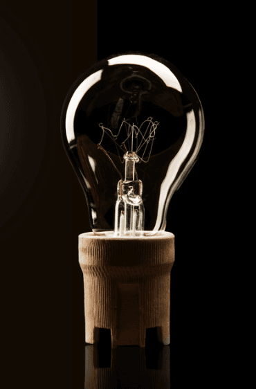 A light bulb glowing softly in the dark